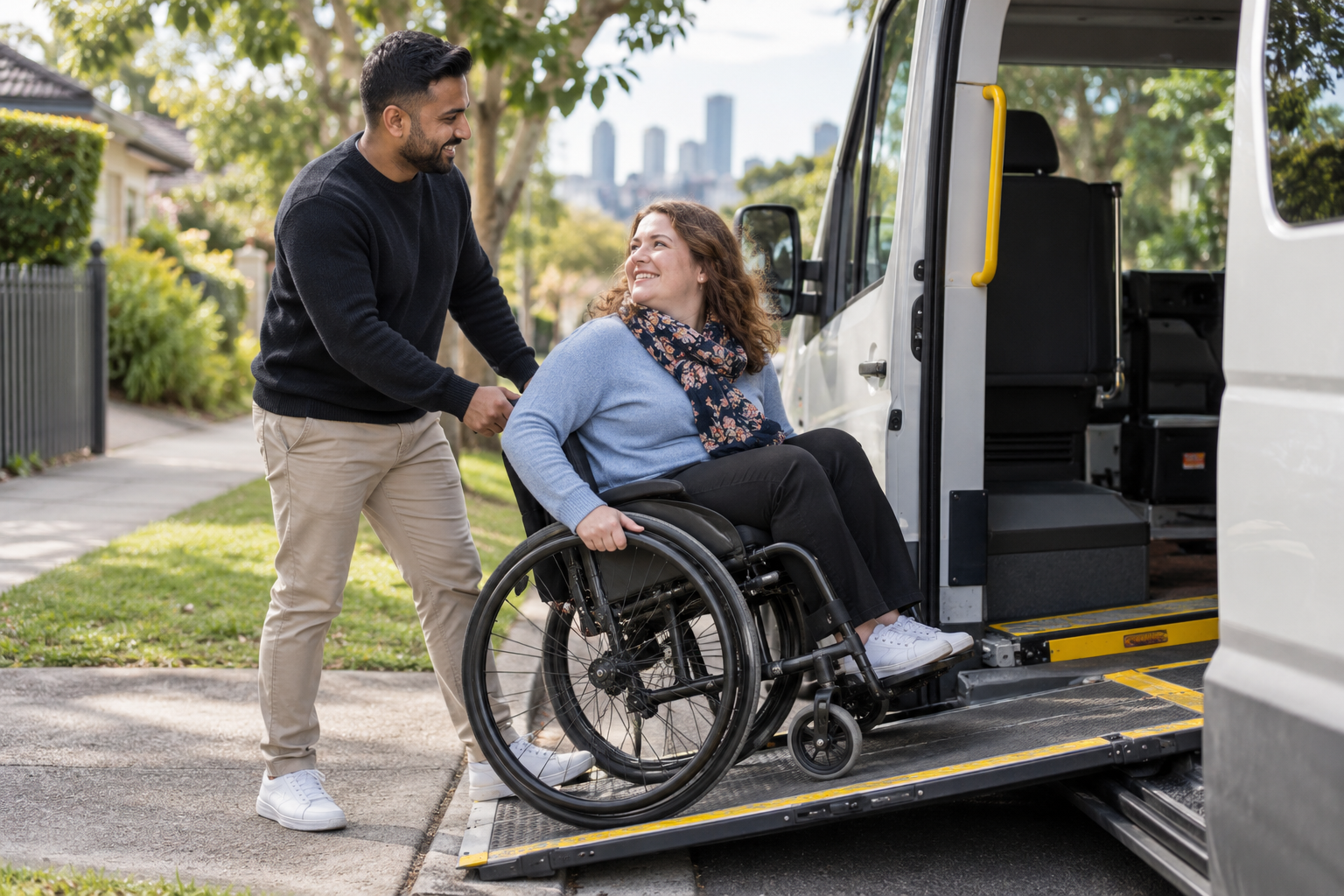 A support professional assisting a wheelchair user to board accessible community transport